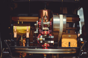 Fototapeta premium beautiful retro steam engine, polished and well-groomed, made of copper and wood brass, background image of the old mechanism