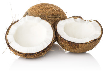 Coconut and one cracked in two halves isolated on white background brown fibrous shell with milk meat.
