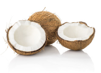 Two coconut halves and one whole isolated on white background brown fibrous shell with milk meat.