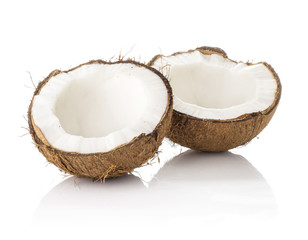 Two coconut halves isolated on white background one broken in two brown fibrous shell with milk meat.