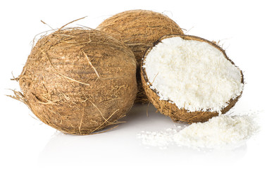 Two coconuts and one broken half filled with shavings isolated on white background brown fibrous shell with milk meat.