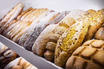 freshly baked bread and bakery products on the counter. background of different types of bread, bread rolls and products