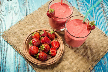 healthy strawberry yogurt with fresh berries on old wooden background
