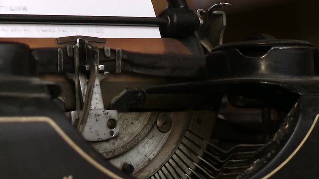 Writer typing with retro writing machine. View from above.