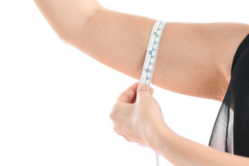 Woman measuring her arm fat on white background.
