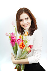Beautiful girl with a Bouquet of Tulip flowers. Isolated on a white background.
