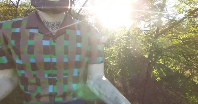 Camera starts low and rises up and above a giant Paul Bunyan that used to hold a muffler in his hands, in days of old.  Now painted with hairy chest.