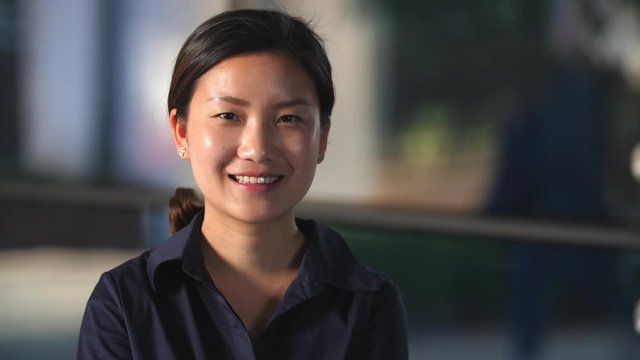 Portrait of Happy Young asian woman smile at camera in Slow Motion, 4k