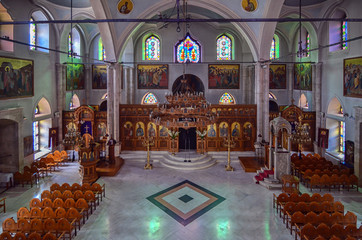 Heraklion, Crete Island / Greece: Agios Titos Orthodox church interior view. Sun light entering through the stained windows creating colorful reflections. Dedicated to saint Titus