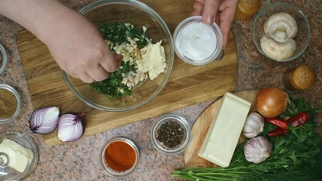 Top view of unrecognizable cooking salting mix of chopped parsley, garlic and sour cream