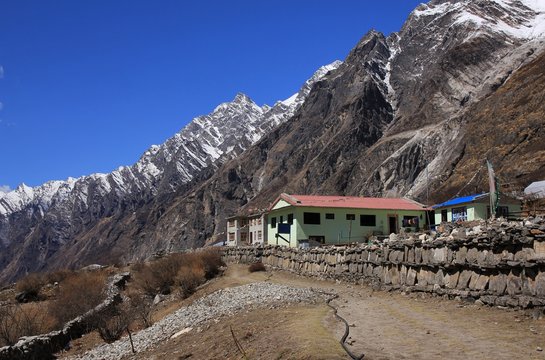 Hotel in Mundu. View down the Langtang valley, Nepal. Sunny spring day in the Himalayas.