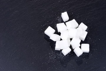 Pile of sugar cubes isolated on black background