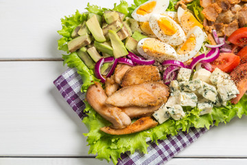 Cobb salad with fried chicken, avocado, eggs and tomatoes