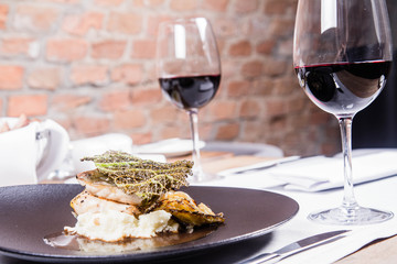 Sturgeon, savoy cabbage, mushrooms broth, mashed potato with butter served in a restaurant