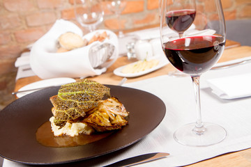 Sturgeon, savoy cabbage, mushrooms broth, mashed potato with butter served in a restaurant