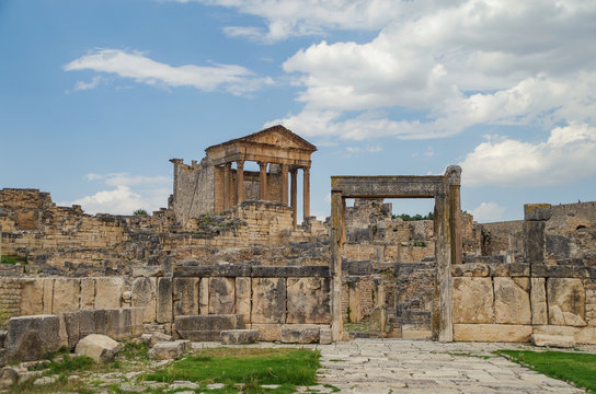 Roman ruins. The door of the Dar Lacheb ("House of Lacheb", or "Domus Lachebia") and roman temple Capitol in background. Dougga or Thugga, Romano-Berber city - UNESCO World Heritage site. Tunisia