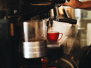 Asian man making a coffee in cafe.