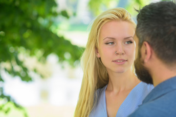 Obraz premium First meet of strangers, girl looks at bearded man
