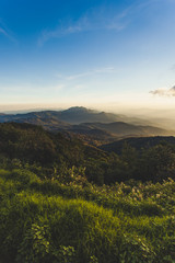 Smoky mountain landscape with mountain and light rays before sunset.