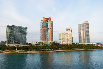 Buildings of miami, usa on sea shore. Building houses on cloudy sky