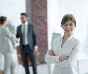 portrait of young business woman on the background of the office