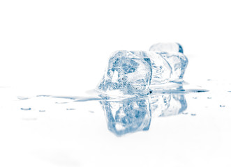 Ice cubes on mirroring reflective surface.