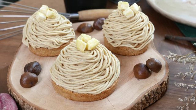 Mont Blanc Dessert or Chestnut Cream cake a dessert filled mostly with whipped cream. set on wooden table