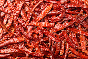 food background of dried red chilies, top view