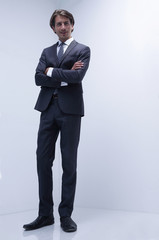 serious businessman standing in a blank room.