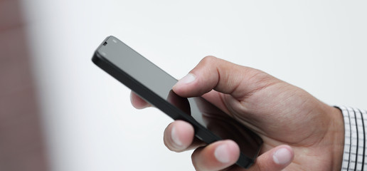closeup.a man holds a smartphone.