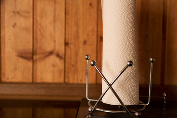 Roll of paper towel on kitchen bench, with timber panels behind - everyday life, cooking, cleaning,...
