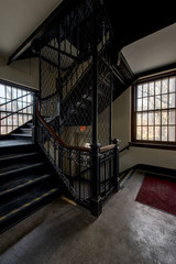 Obraz premium Intricate Cast Iron Staircase - Abandoned Administration Building, Harrisburg State Hospital - Harrisburg, Pennsylvania