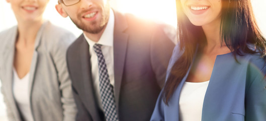Business woman smiling with her colleagues in the background
