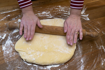 Women's hands prepare a donut dough