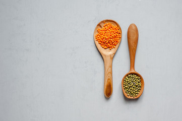 Handmade spoons. Two close-up wooden spoons with lentils and other grains.
