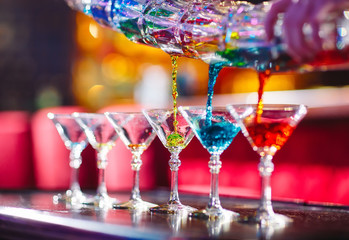 Barman show. Bartender pours alcoholic cocktails.