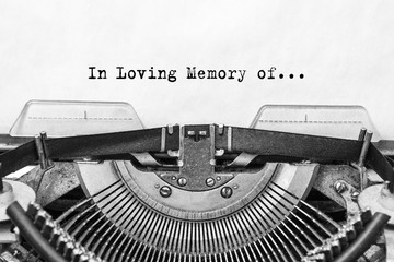 In the Loving Memory of, the text typed on is an old Typewriter. A vintage thing. close-up