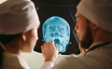 Doctors watching x-ray of patient.