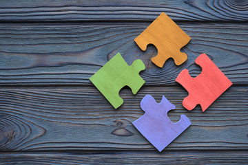 The four parts of the color puzzle are assembled into one. The idea of a business concept, cooperation, teamwork, strategy