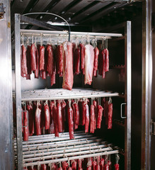 Smoked ham in the oven. Sausage production in the factory.