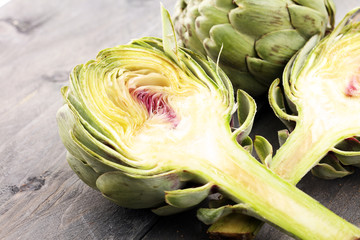 Obraz premium artichokes on grey background. fresh organic artichoke flower.