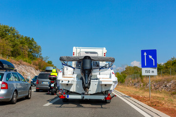 Motorhome with motor boat on the automotive trailer on the road in Istria, Croatia