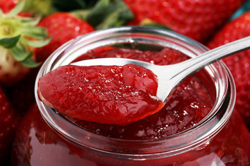 strawberry jam with fresh strawberries. marmalade on spoon and jar