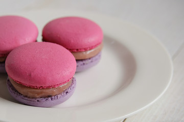 Cherry-blueberry macaroons on a plate