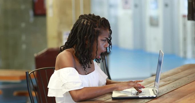 Screaming black woman at laptop,