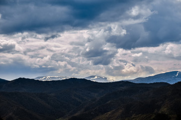 Fototapeta na wymiar Cloudy snow covered mountain peak. Altai, Russia