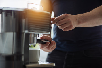 A man prepares espresso for a coffee maker