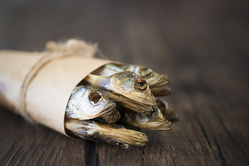 Capelin smoked on brown wooden table.