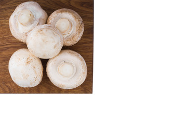 White mushrooms on a wooden cutting Board. Isolate on white background. Top view