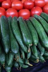 Cucumbers and tomatoes. Fresh organic Homegrown Cucumbers and tomatoes at the open market. Vegetables salad background. 